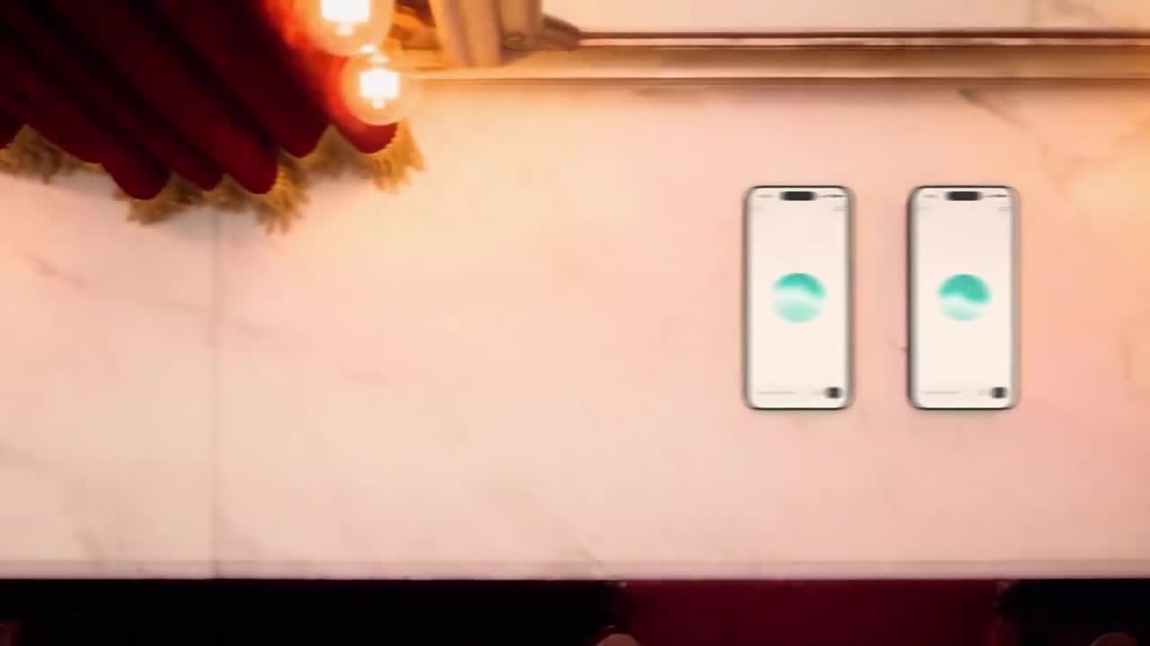Two phones showing ChatGPT Voice orb on a marble surface