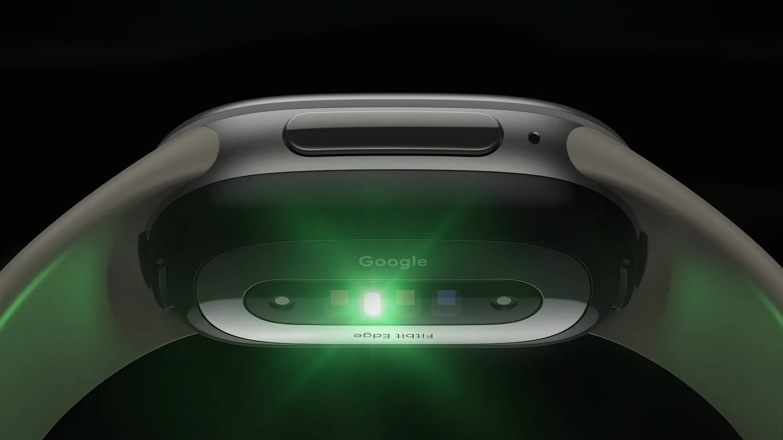 Underside of the Fitbit Edge with its green optical heart rate sensors lit up