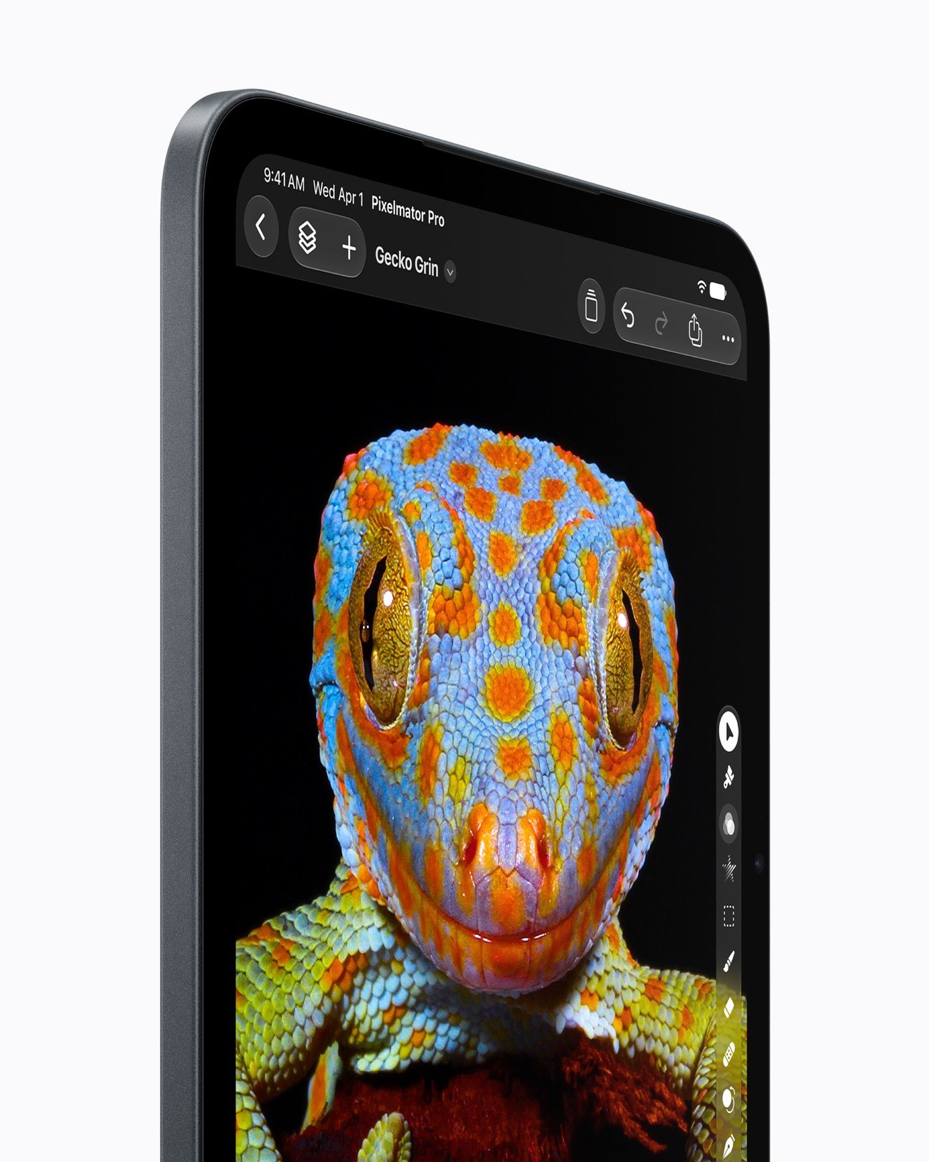 iPad mini OLED display showing a colourful chameleon illustration against a black background