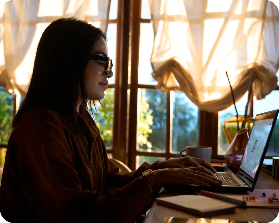 Official Jio image showing a person wearing JioFrames while working at a laptop